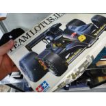 A QUANTITY OF MODEL AIRCRAFT AND RACING CAR KITS BY TAMIYA AND OTHERS.