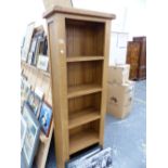 A SMALL MODERN OAK BOOK CASE.