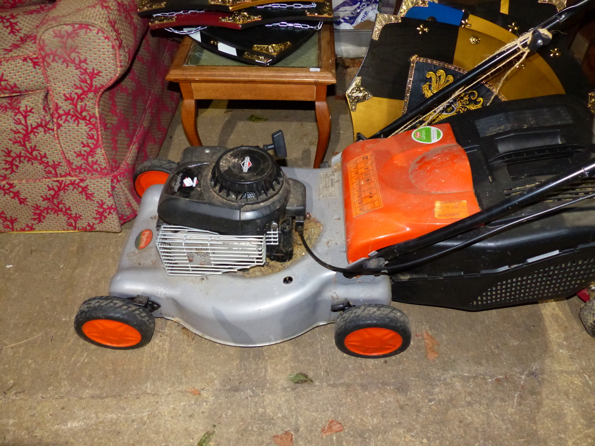 A FLYMO LAWN MOWER WITH BRIGGS & STRATTON PETROL ENGINE.