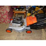 A FLYMO LAWN MOWER WITH BRIGGS & STRATTON PETROL ENGINE.