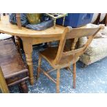A CIRCULAR PINE KITCHEN TABLE AND THREE OXFORD CHAIRS.