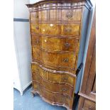 A GEORGE I STYLE WALNUT SERPENTINE FRONT CABINET ON CHEST.