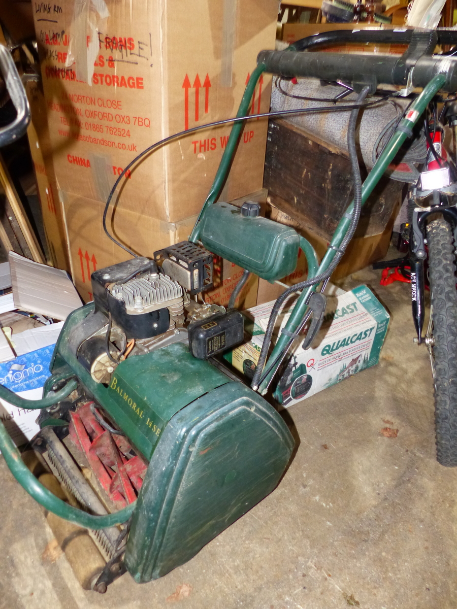 A PETROL PUSH MOWER WITH SCARIFIER CASSETTE ATTACHMENT.