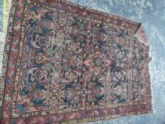 AN ANTIQUE PERSIAN RUG.