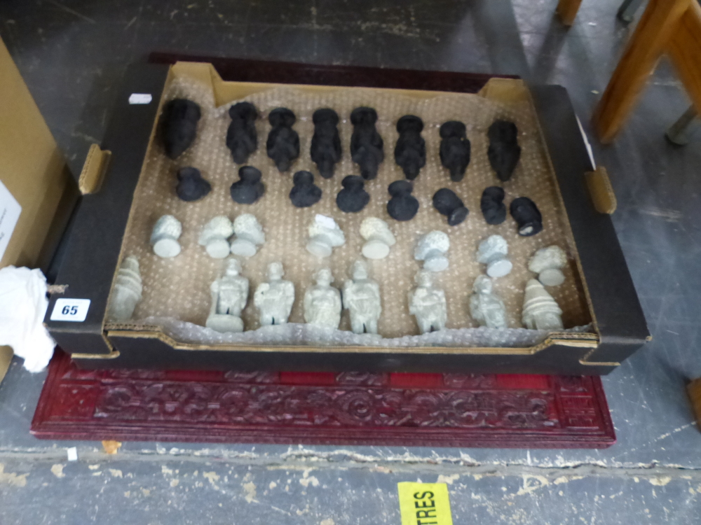 A MODERN CHESS SET AND BOARD, A CARVED HARD STONE DEPICTING TRIBAL FIGURES, TOGETHER WITH AN ART