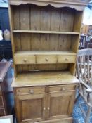 A SMALL PINE KITCHEN DRESSER.