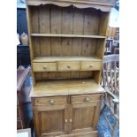 A SMALL PINE KITCHEN DRESSER.