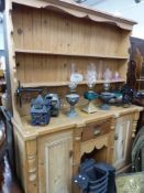 AN ANTIQUE AND LATER PINE KITCHEN DRESSER.