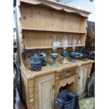 AN ANTIQUE AND LATER PINE KITCHEN DRESSER.