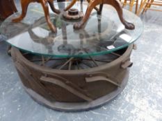 AN INDUSTRIAL IRON AND GLASS COFFEE TABLE.
