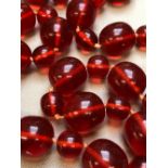 A ROW OF MULTI RED UNTESTED BEADS, KNOTTED. LENGTH 80cms, LARGEST BEAD APPROX 18.5mm, WEIGHT