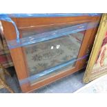 A SMALL MAHOGANY SIDE CABINET WITH GLAZED DOORS.