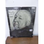 A SIGNED PHOTOGRAPHIC PRINT OF ALFRED HITCHCOCK.