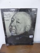 A SIGNED PHOTOGRAPHIC PRINT OF ALFRED HITCHCOCK.