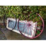 A PAIR OF VINTAGE CAST IRON WAGON WHEELS.
