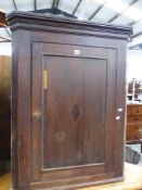 A GEORGIAN OAK CORNER CABINET.