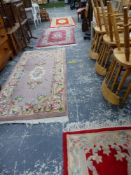 FOUR VARIOUS CHINESE WOOL RUGS.