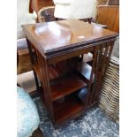 AN EDWARDIAN INLAID MAHOGANY REVOLVING BOOK CASE.