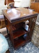 AN EDWARDIAN INLAID MAHOGANY REVOLVING BOOK CASE.