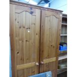 A PAIR OF PINE TWO DOOR WARDROBES.