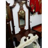 A VICTORIAN MAHOGANY HALL STAND AND AN OVAL MANTLE MIRROR.