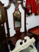 A VICTORIAN MAHOGANY HALL STAND AND AN OVAL MANTLE MIRROR.