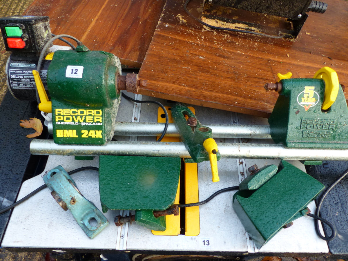 AN ELECTRIC RECORD POWER DML24X WOODWORKING LATHE.