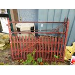 A PAIR OF GOOD QUALITY PAINTED IRON DRIVEWAY GATES AND ONE OTHER IRON GATE.