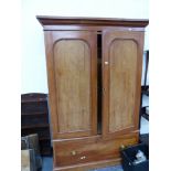 A VICTORIAN STAINED PINE WARDROBE AND A SMALL OAK BOOKCASE.
