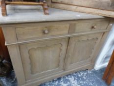 AN ANTIQUE PINE SIDE CABINET WITH TWO DRAWERS.