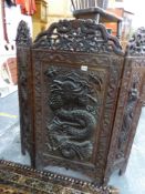 AN EASTERN HARDWOOD CARVED THREE FOLD SCREEN.