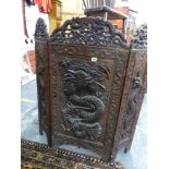 AN EASTERN HARDWOOD CARVED THREE FOLD SCREEN.