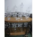FOUR POMACK CLEAR GLASS STORAGE VESSELS AND COVERS, THE TALLEST. H 63cms. TWO VARIOUS COVERS, TWO