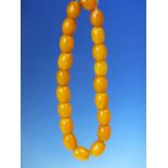 A CONTINUOUS STRING OF 20 UNIFORM ETHIOPIAN AMBER BEADS PROBABLY FIRST HALF OF THE 20th C. MEASURING