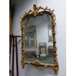 A RECTANGULAR MIRROR IN FAUX BOIS AND GILT FRAME, PIERCED FOLIAGE CRESTING THE ROUNDED TOP AND VINES