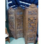 AN ANTIQUE INDIAN CARVED FOUR FOLD FLOOR SCREEN. CARVED BOTH SIDES WITH VARIOUS FOLIATE AND FLORAL