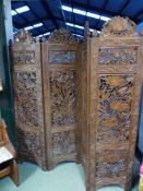 AN ANTIQUE INDIAN CARVED FOUR FOLD FLOOR SCREEN. CARVED BOTH SIDES WITH VARIOUS FOLIATE AND FLORAL