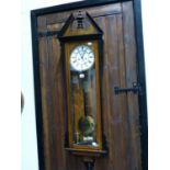 AN EBONY TRIMMED ROSEWOOD CASED VIENNA REGULATOR STRIKING ON A COILED ROD, THE WHITE ENAMEL