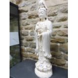 A BLANC DE CHINE FIGURE OF GUANYIN STANDING ON A DOUBLE LOTUS PLINTH, HER RIGHT HAND RAISED IN