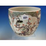 A CHINESE FAMILLE VERTE PLANTER PAINTED WITH FOUR PANELS OF FLOWERS AND BIRDS ON A BLACK STIPPLED