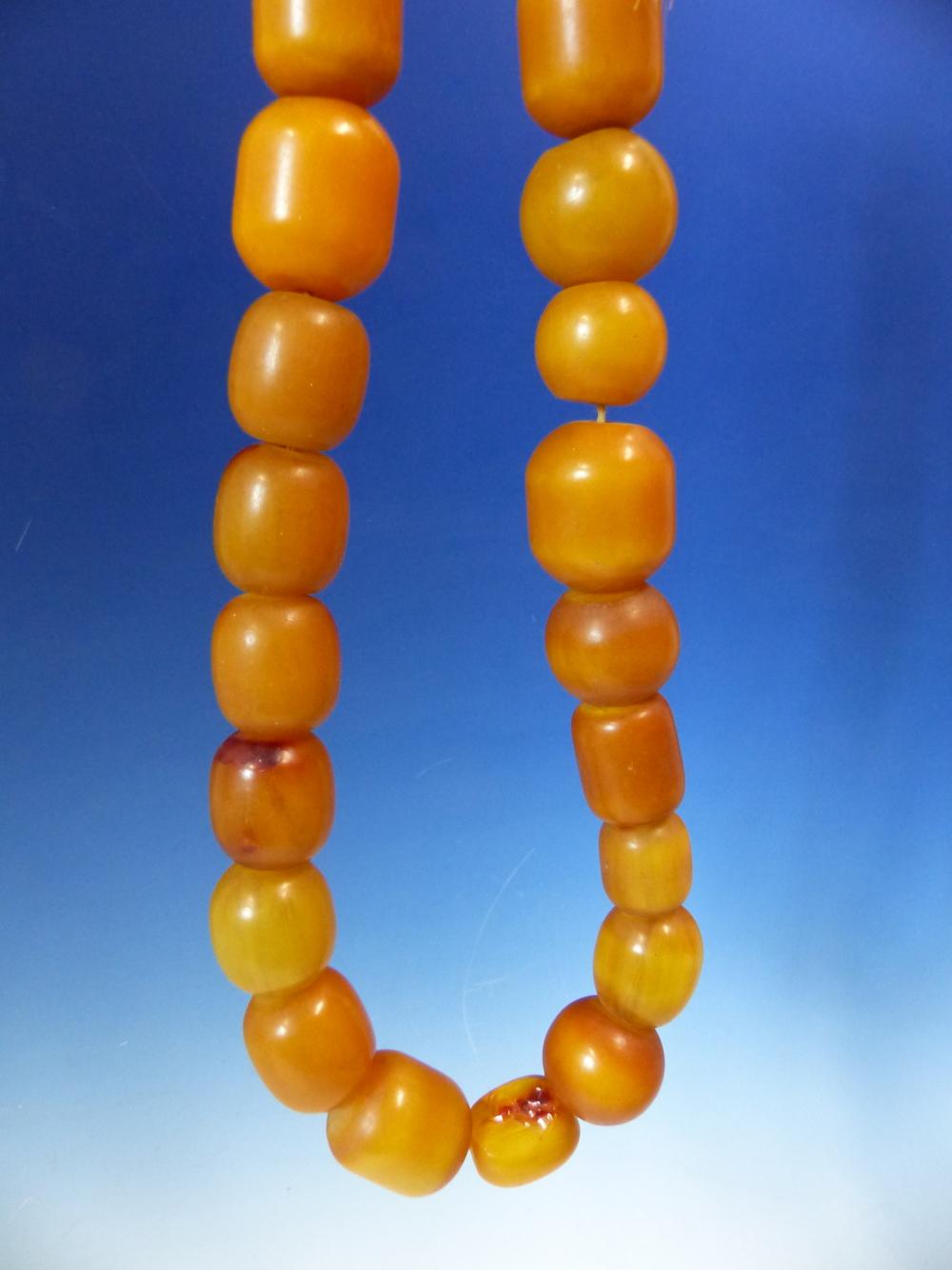 A STRING OF 27 ETHIOPIAN AMBER BEADS, PROBABLY FIRST HALF OF THE 20th.C. VARYING IN SHAPE AND - Image 3 of 4