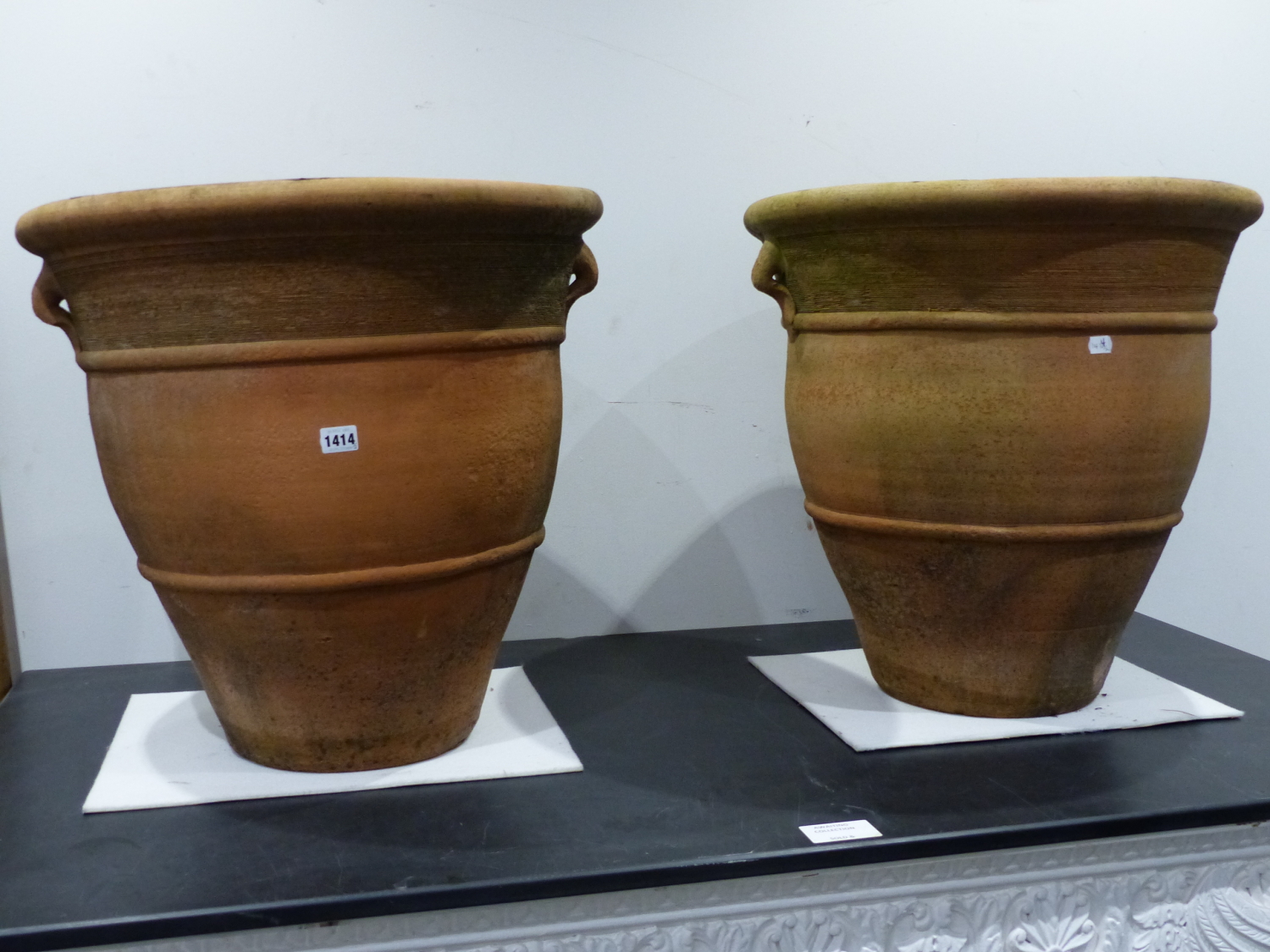 A PAIR OF TERRACOTTA TWIN HANDLE BALUSTER FORM GARDEN PLANTERS. H. 56 x Dia. 56cms. (2).