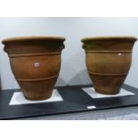 A PAIR OF TERRACOTTA TWIN HANDLE BALUSTER FORM GARDEN PLANTERS. H. 56 x Dia. 56cms. (2).