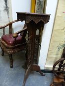 AN ISLAMIC PIERCED AND CARVED WOOD HEXAGONAL TRIPOD TORCHERE. W 39 x D 34 x H 102cms.