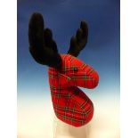 AN AS NEW NOVELTY REINDEER DOORSTOP OF TARTAN FABRIC.