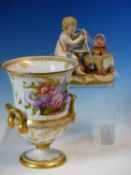 A MEISSEN FIGURE OF A PUTTO SEATED AT A TEA TABLE WHILE A BRAZIER BOILS THE KETTLE, CROSSED SWORDS