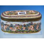 A CAPO DI MONTE PORCELAIN BOX, THE HINGED LID AND ELONGATED OVAL SIDES MOULDED IN RELIEF AND PAINTED