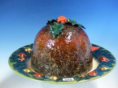 A DENNIS CHINA WORKS CHRISTMAS PUDDING DISH AND HOLLY TRIMMED COVER DESIGNED BY SALLY TUFFIN, THE