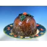 A DENNIS CHINA WORKS CHRISTMAS PUDDING DISH AND HOLLY TRIMMED COVER DESIGNED BY SALLY TUFFIN, THE