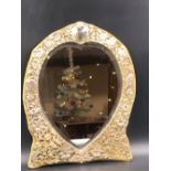 AN ANTIQUE VICTORIAN HEART SHAPED SILVER FRAMED AND WOODEN EASEL BACKED DRESSING TABLE MIRROR. THE